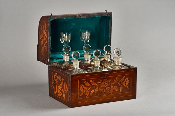 An early 19th century floral marquetry inlaid walnut decanter box, the dome top enclosing six gilt decorated decanters and a pair of liquor glasses, 2