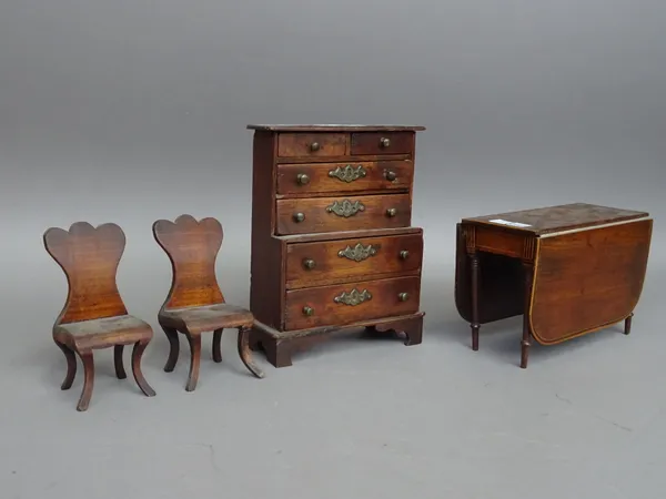 A suite of miniature furniture, to comprise; a dresser 17cm wide x 22cm high, a Regency drop flap table 20cm wide x 14cm high and a pair of hall chair