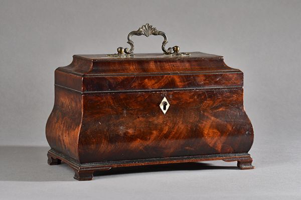 A mid-18th century mahogany tea caddy, of bloated sarcophagus form, on ogee bracket feet, 25cm wide x 16cm high. Illustrated.