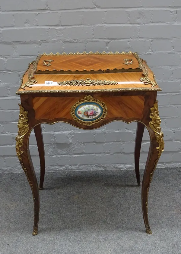 A late 19th century gilt metal and ceramic mounted Kingwood jardiniere, of serpentine outline on cabriole supports, 65cm wide x 83cm high.