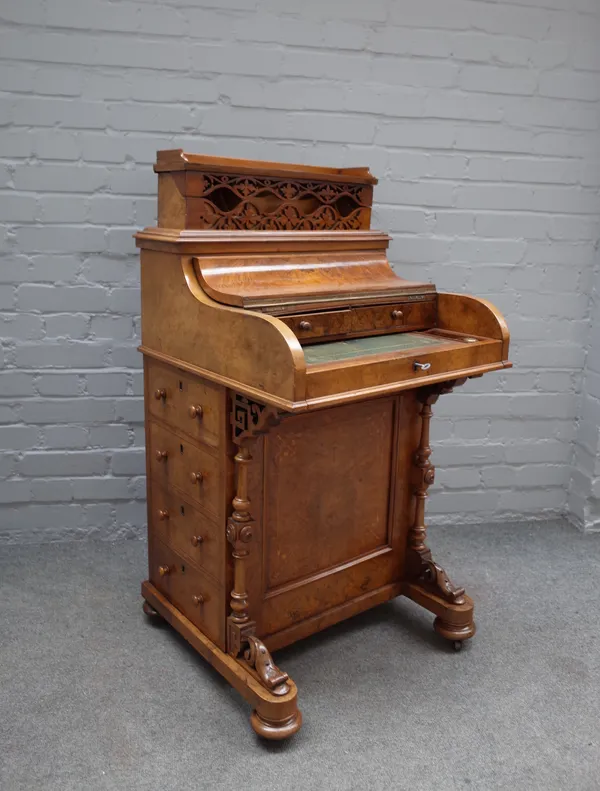 A Victorian walnut piano 'pop-up' Harlequin Davenport, with four side drawers and turned supports, 56cm wide x 85cm high.