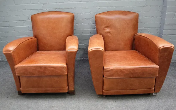 A pair of 20th century brown leather upholstered easy armchairs, on block supports, 80cm wide x 76cm high (2).