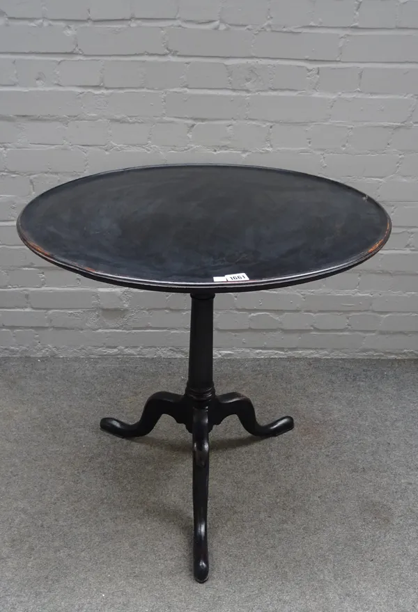 A mid-18th century mahogany occasional table, the circular snap top on tripod base, 73cm deep x 74cm high.