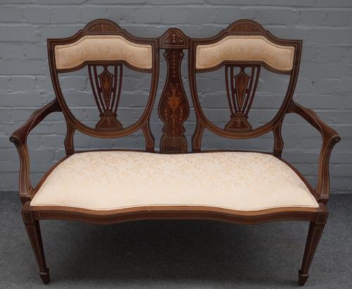 An Edwardian marquetry inlaid mahogany double chair back show frame sofa, on tapering square supports, 120cm wide x 94cm high.
