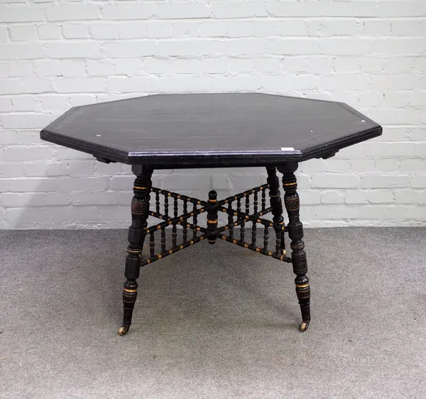 Howard and Sons; a Victorian parcel gilt ebonised octagonal centre table, on turned supports, 108cm wide x 69cm high.