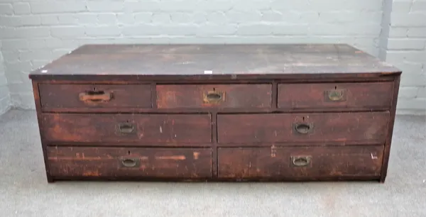 An early 20th century mahogany side cabinet/ tool chest with an arrangement of seven drawers, 147cm wide x 50cm high.