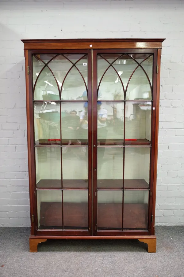 A George III mahogany glazed two door floor standing display cupboard, on later bracket feet, 123cm wide x 195cm high.