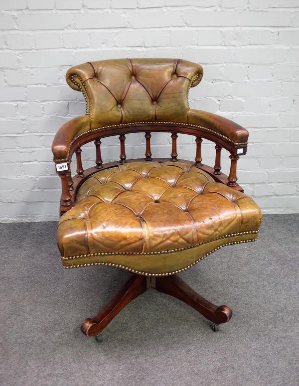 A 20th century green leather upholstered tub back swivel office chair, 65cm wide x 86cm high,