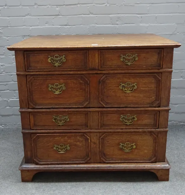 A late 17th century oak two part chest of four long geometric moulded drawers on bracket feet, 91cm wide x 84cm high.