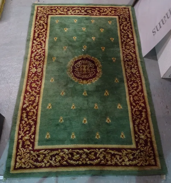 A green carpet with bee design, 303cm x 202cm.
