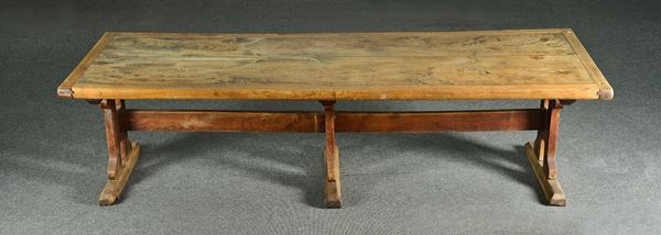 A large elm refectory table, the 19th century and later cleated twin plank top, on a trio of pierced trestle supports, united by thick stretcher, 104c