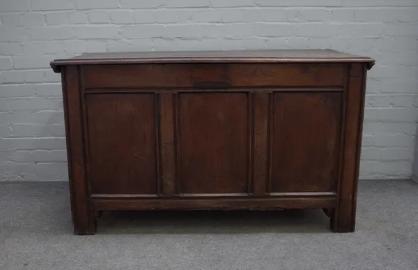 A 17th century oak coffer with twin plank top over double panel front, 130cm wide x 77cm high.