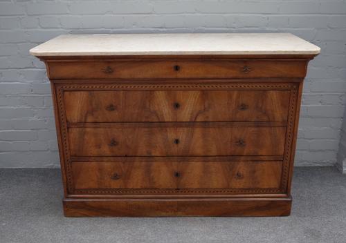 A 19th century French commode, the marble top over an inlaid walnut base of four long graduated drawers, 129cm wide x 87cm high.