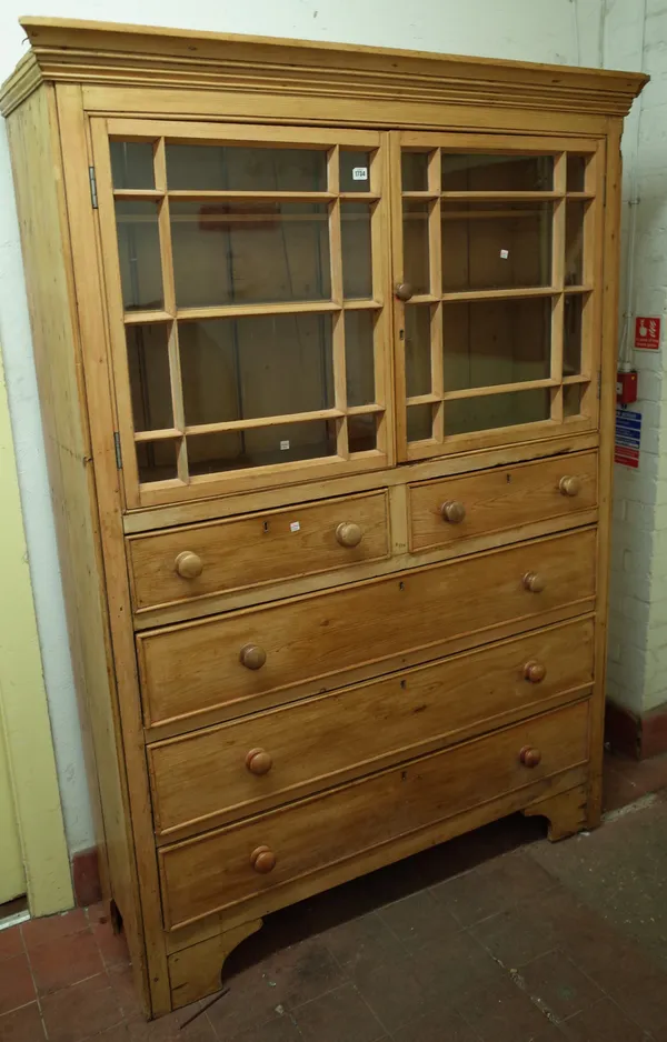 A 19th century pine food cupboard, the pair of glazed doors over two short and three long drawers on bracket feet, 137cm wide x 193cm high.