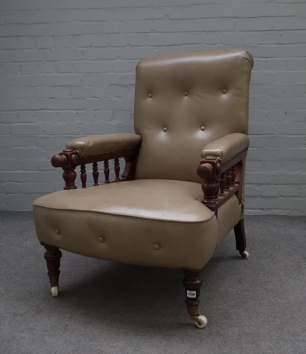 A mid-19th century leather upholstered easy armchair, the turned finials rotating to adjust the back angle, resting on turned supports, 70cm wide x 96