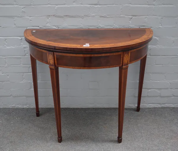 A George III satinwood banded mahogany demi-lune card table, on tapering square supports, 92cm wide x 75cm high.