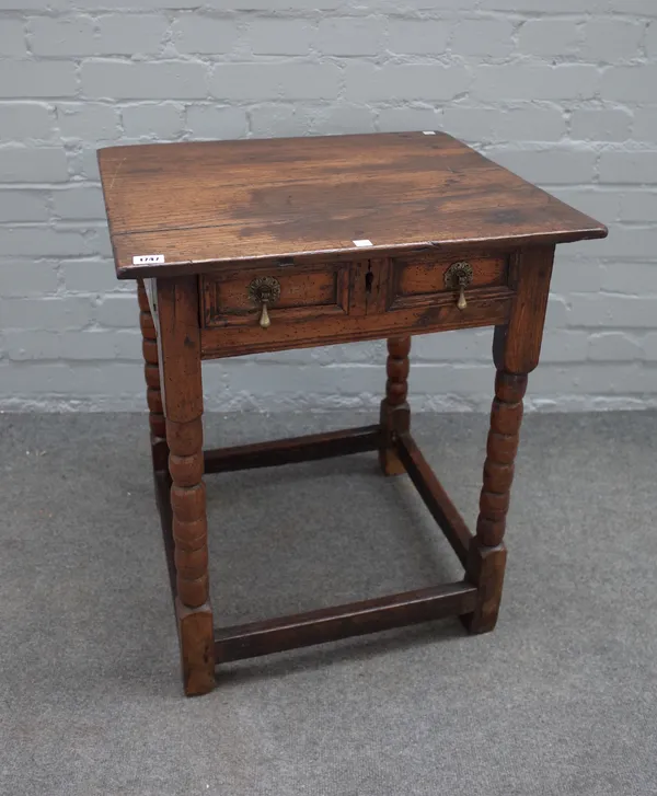 A Charles II and later oak side table with single raised moulded drawer on turned supports, 58cm wide x 66cm high.