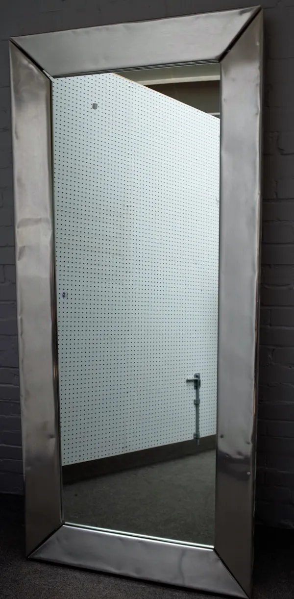 A 20th century rectangular mirror, with folded polished steel frame, 198cm wide x 90cm high.