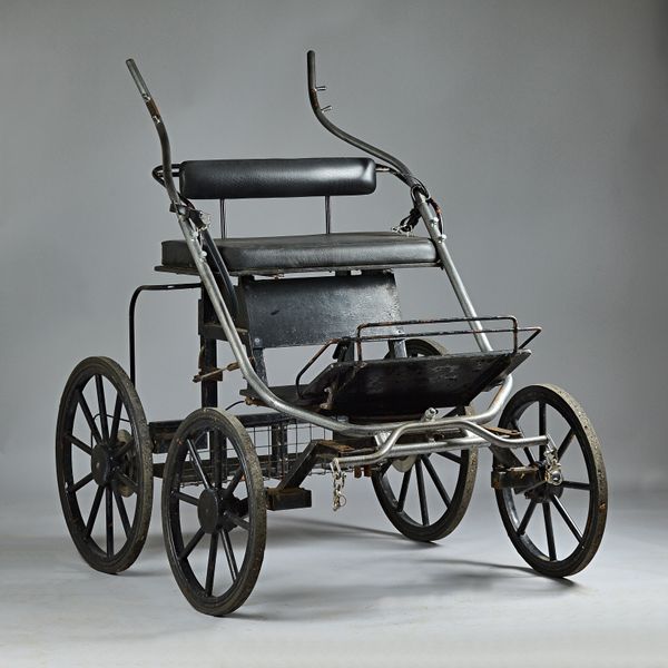 A 20th century four wheel light weight competitive horse carriage/ cart, with disc brakes, 120cm wide x 127cm high. Illustrated.