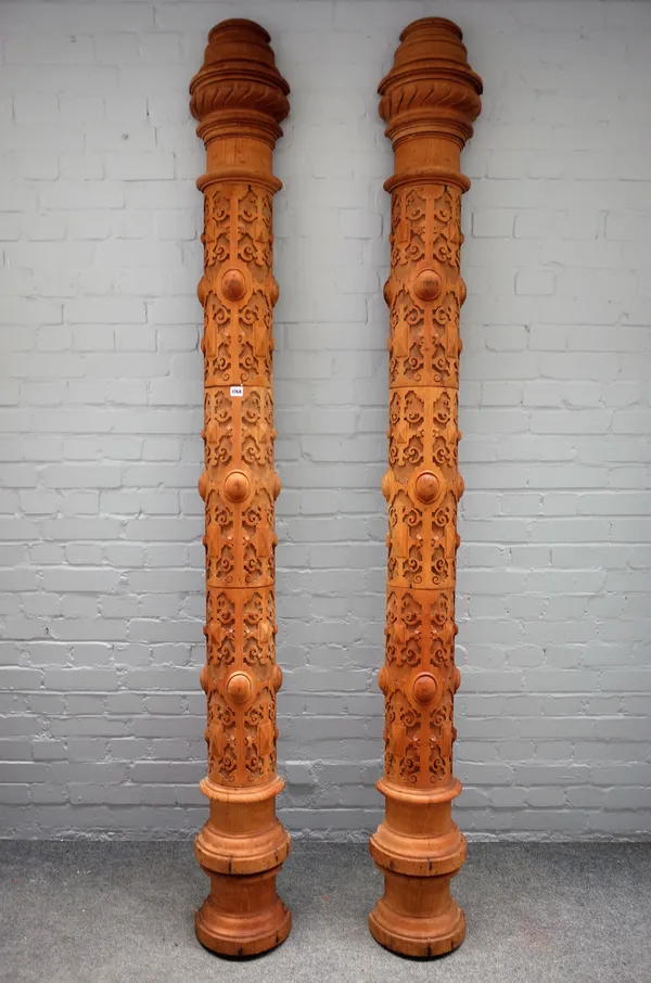 A pair of carved Victorian Gothic Revival style bleached mahogany semi-elliptic columns, 240cm high x 26cm wide, (2).