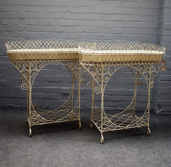 A pair of Edwardian white painted wirework rounded rectangular plant stands, 90cm wide x 90cm high, (2).