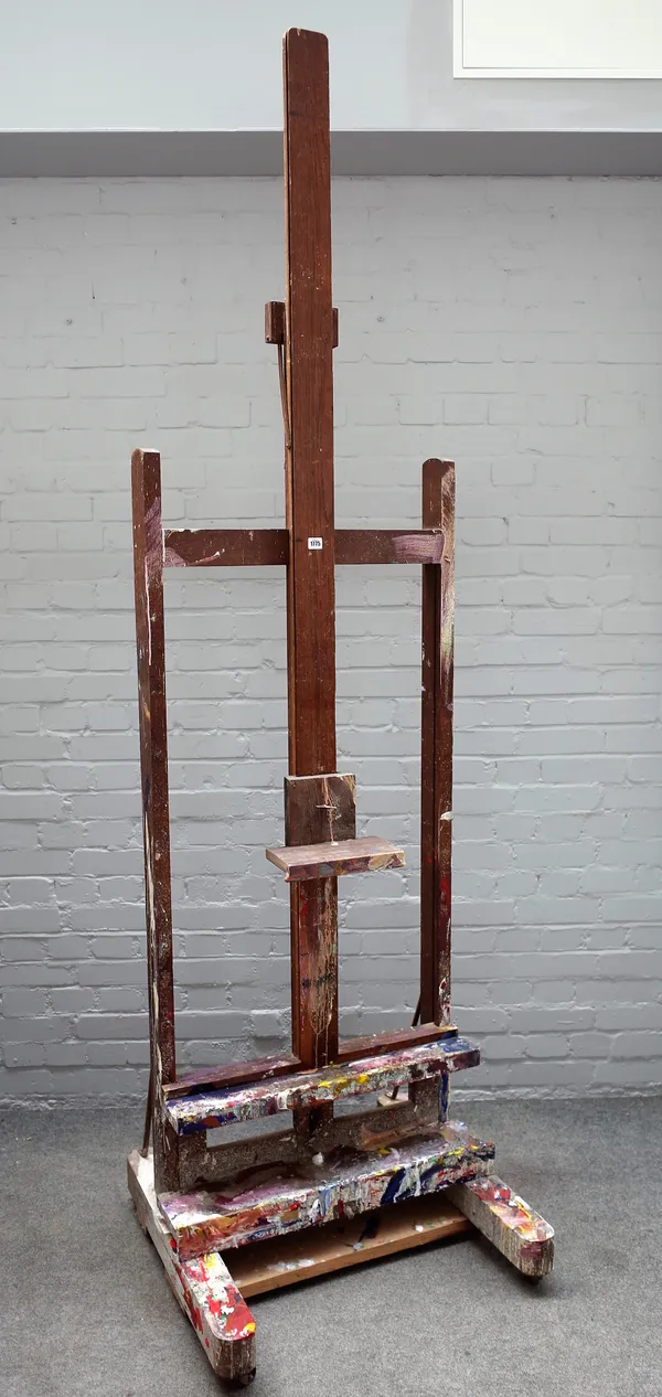 A 20th century oak artist's easel with ratchet height adjustment, 73cm wide at base.