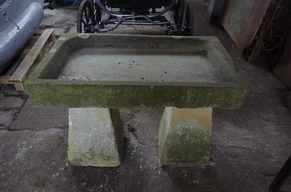 A rectangular carved stone sink/birdbath, on two tapering square staddle stone columns, 97cm wide x 75cm high.