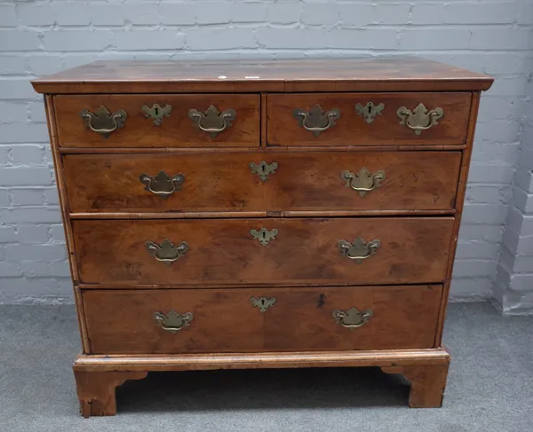 An early 18th century feather banded walnut chest with two short and three long graduated drawers on bracket feet, 106cm wide x 95cm high.