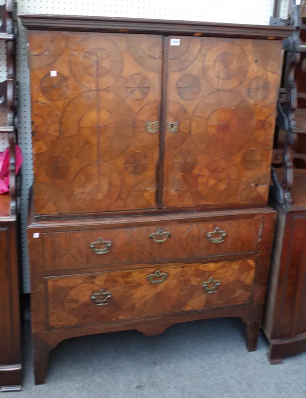 A late 17th century Continental oyster Kingwood cabinet, the pair of doors enclosing a fitted interior over a two drawer base on high bracket feet, al