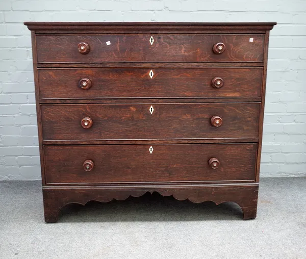 A George III oak chest of four long graduated drawers, on bracket feet, 126cm wide x 109cm high.