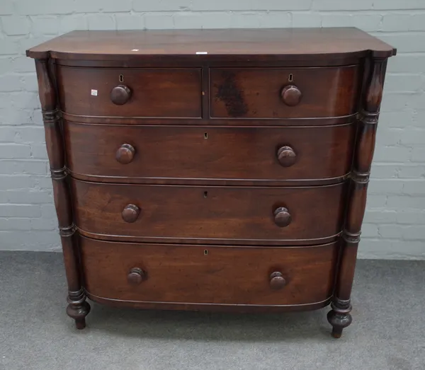 A Regency mahogany bowfront chest of two short and three long graduated drawers, flanked by split turned columns, 112cm wide x 109cm high.