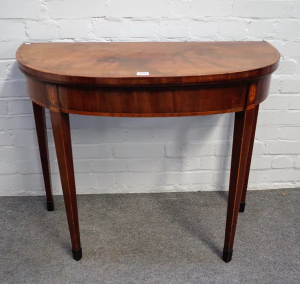 A George III kingwood banded mahogany semi-elliptic card table, on tapering square supports, 91cm wide x 75cm high.