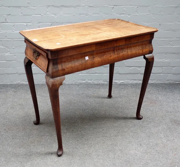 An 18th century and later mahogany silver table, the dished rectangular top with re-entrant corners, the cushion frieze with pair of end drawers, on s