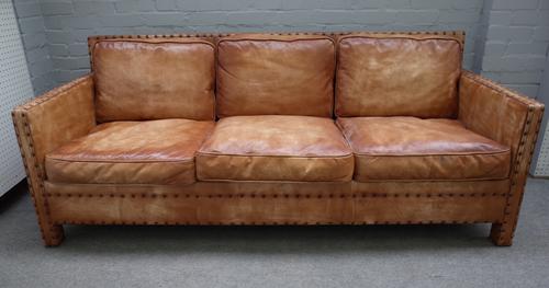 A mid-20th century three seater studded brown leather upholstered square back sofa, 203cm wide x 80cm high.