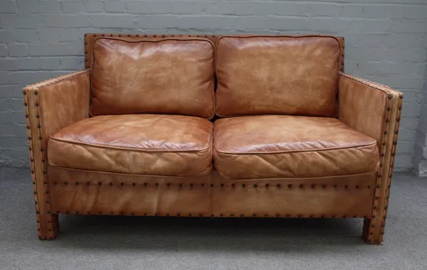 A mid-20th century two seater studded brown leather upholstered square back sofa, 141cm wide x 80cm high.