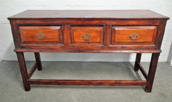 A 18th century stained pine dresser base, with three frieze drawers on block supports, 142cm wide x 81cm high.