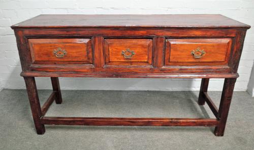 A 18th century stained pine dresser base, with three frieze drawers on block supports, 142cm wide x 81cm high.