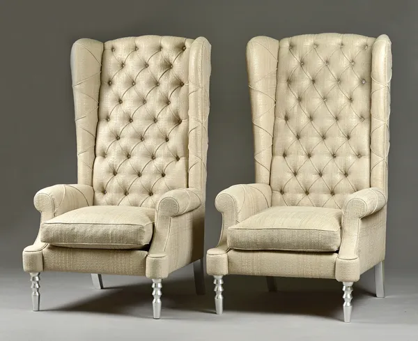 A pair of 20th century diamante studded high wingback armchairs, on turned silvered supports, 85cm wide x 150cm high (2).