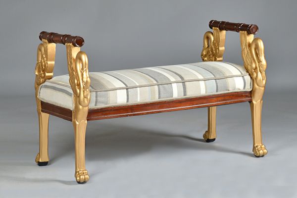 A French Empire Revival gilt framed window seat, on four opposing swan supports, on paw feet, 109cm wide x 70cm high. Illustrated.