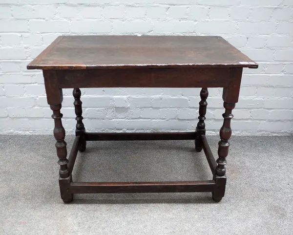 A 17th century oak rectangular side table on baluster supports, 86cm wide x 68cm high.