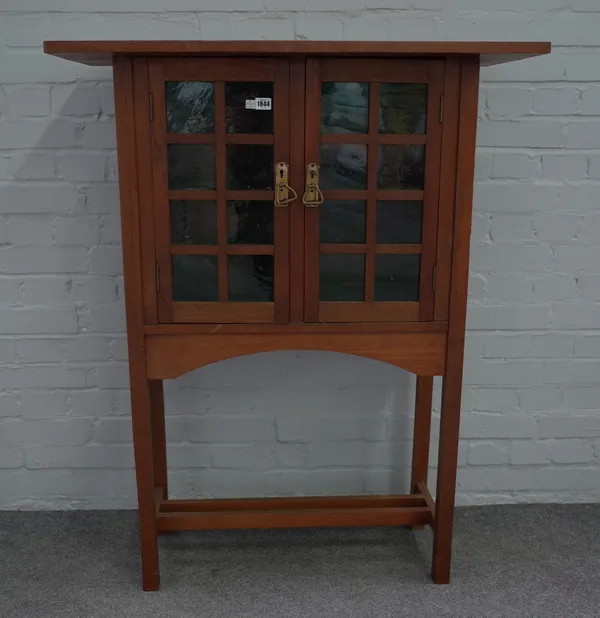 After George Walton; an early 20th century 'Holland' two door side cabinet on block supports, 93cm wide x 119cm high.