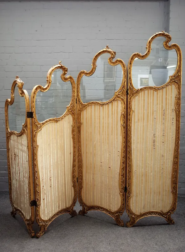 A 19th century French gilt framed four fold semi-glazed dressing screen, with graduating scroll crest and moulded frame, 220cm wide x 196cm high.