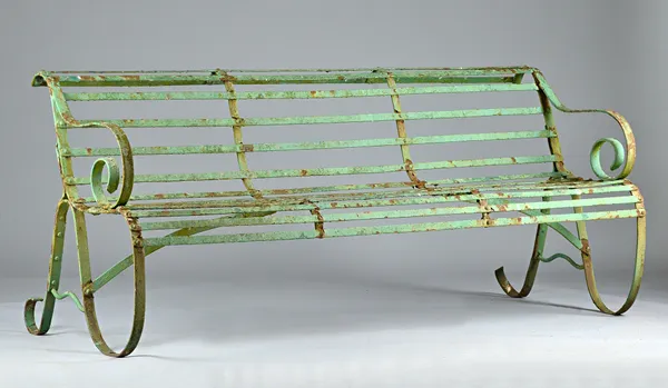 A late 19th century green painted wrought iron bench of Regency design, 182cm wide x 80cm high. Illustrated.