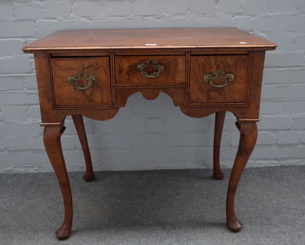 A mid-18th century walnut three drawer lowboy on cabriole supports, 77cm wide x 70cm high.