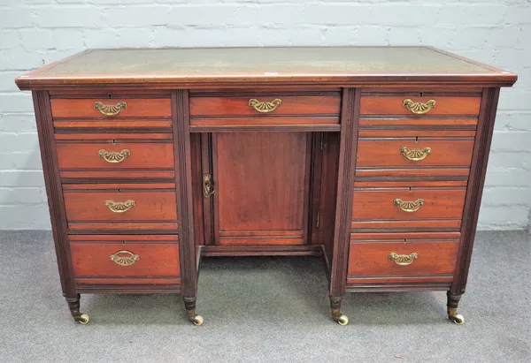 A late Victorian mahogany kneehole writing desk with nine drawers about the cupboard, 123cm wide x 76cm high.