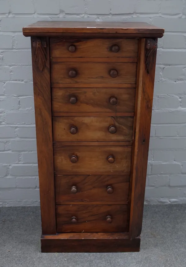 A Victorian walnut Wellington chest, the seven drawers enclosed by side locking bar, 50cm wide x 102cm high.