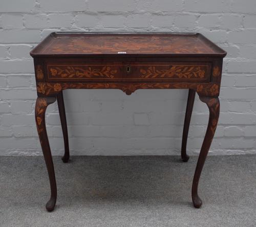 A late 18th century/ early 19th century Dutch marquetry inlaid silver table, the dished rectangular top over frieze drawers stamped 'EDWARDS & ROBERTS