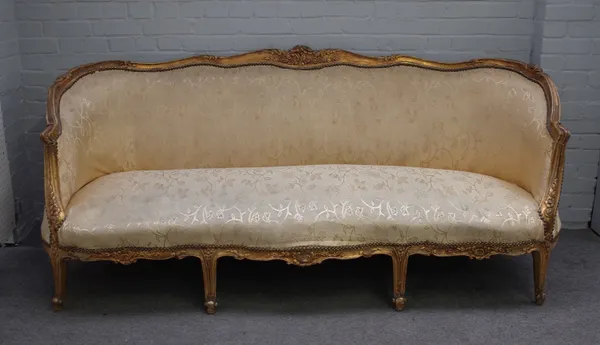 A Louis XVI style gilt framed sofa with shaped back and double serpentine seat, 215cm wide x 93cm high.