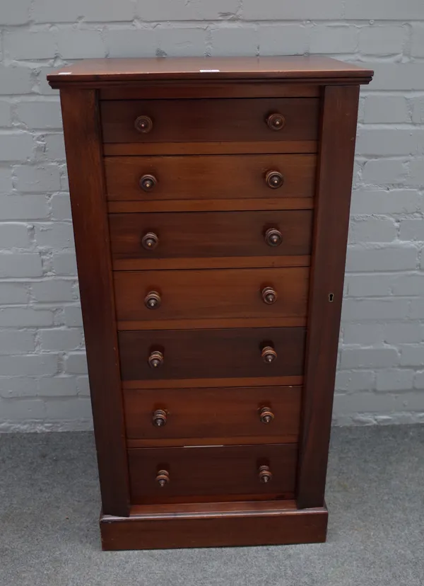 A Victorian mahogany Wellington chest with seven drawers enclosed by double locking bar on plinth base, 54cm wide 106cm high.