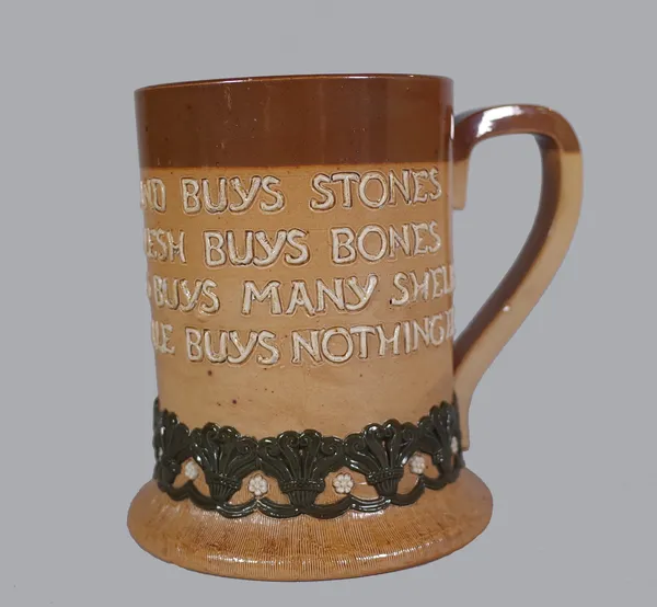 Doulton Lambeth; a motto decorated stoneware mug "… He that buys good ale buys nothing else", impressed mark, 13.5cm high.